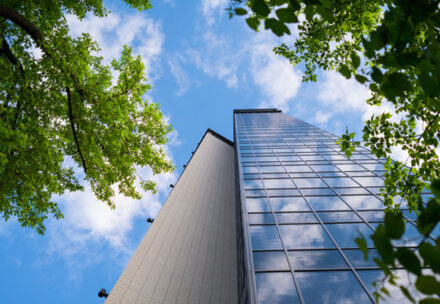 Top 3 Underrated Commercial Property Management Services feature blog image with tall commercial building